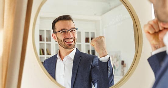 Man in the mirror.jpeg Man in the mirror shows a gesture of success